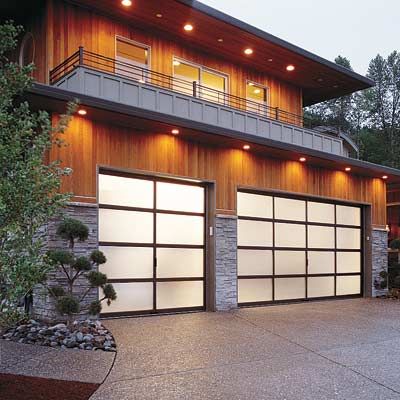 A modern house with modern frosted glass garage doors.