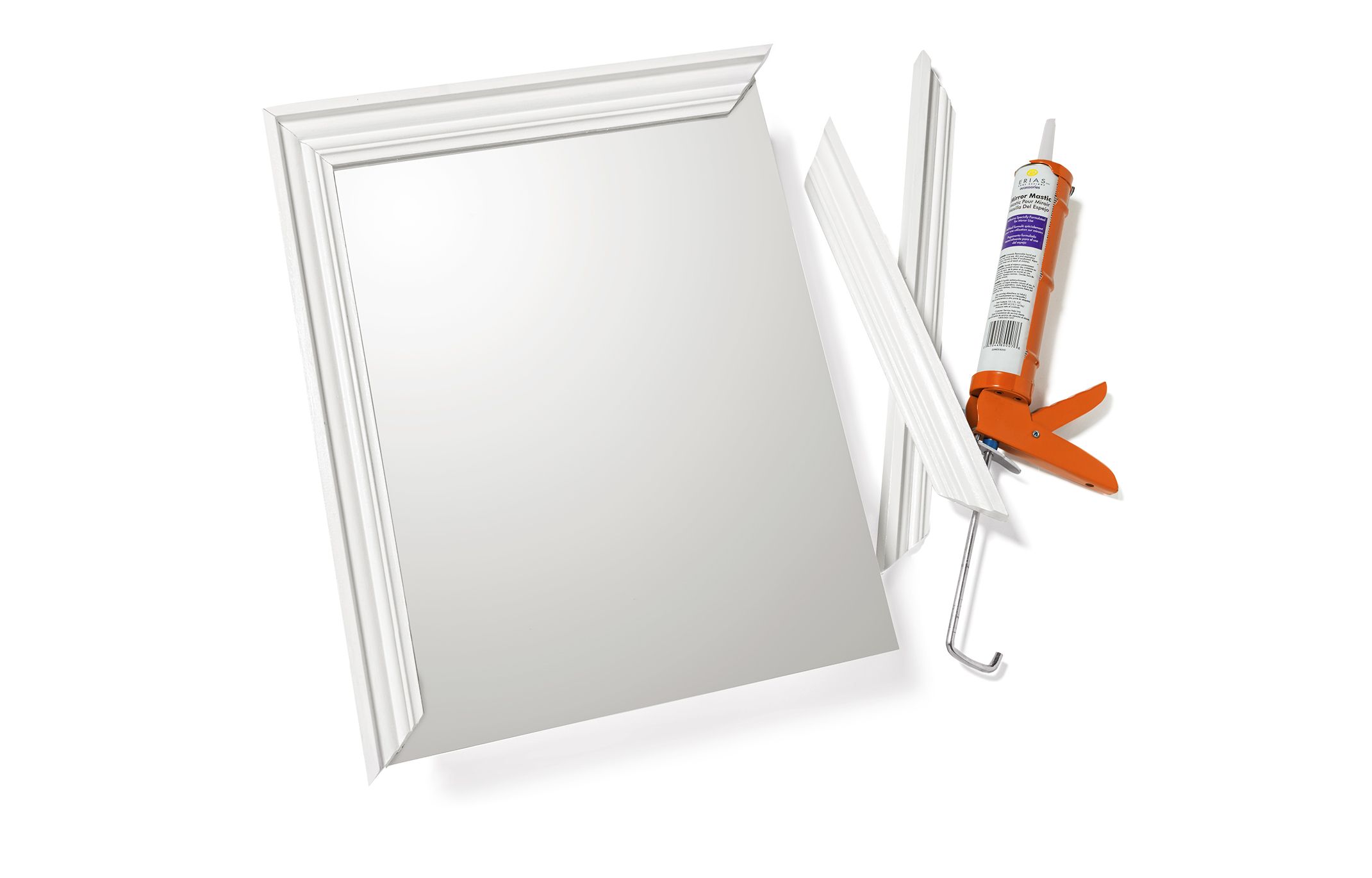 A frame being added to a medicine cabinet mirror.