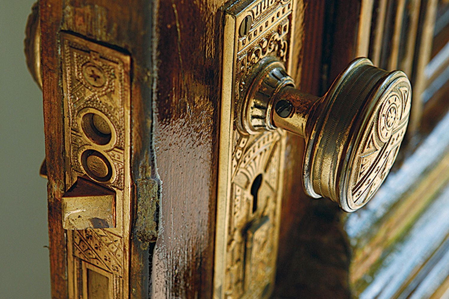 A doorknob attached to a brown door.