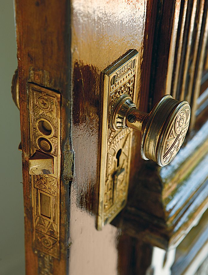 A doorknob attached to a brown door.