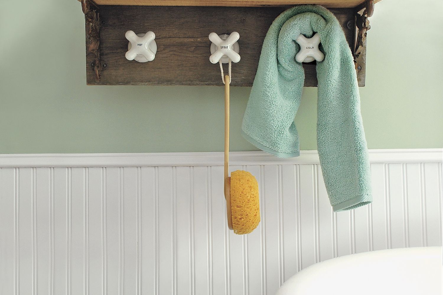 A DIY towel rack made using vintage taps as towel hooks.