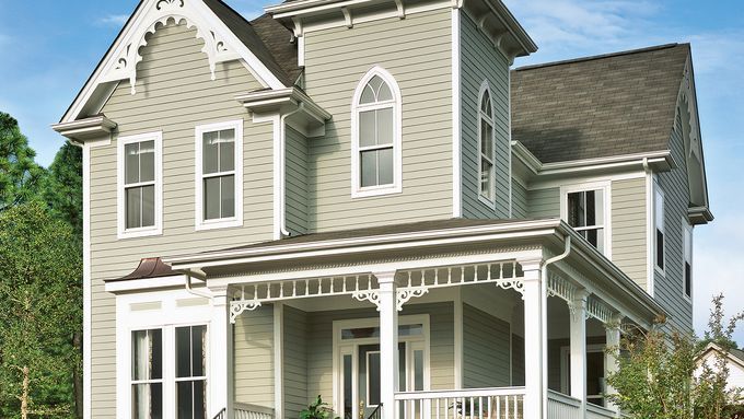 A beige home with fiber cement siding, on a brick platform.