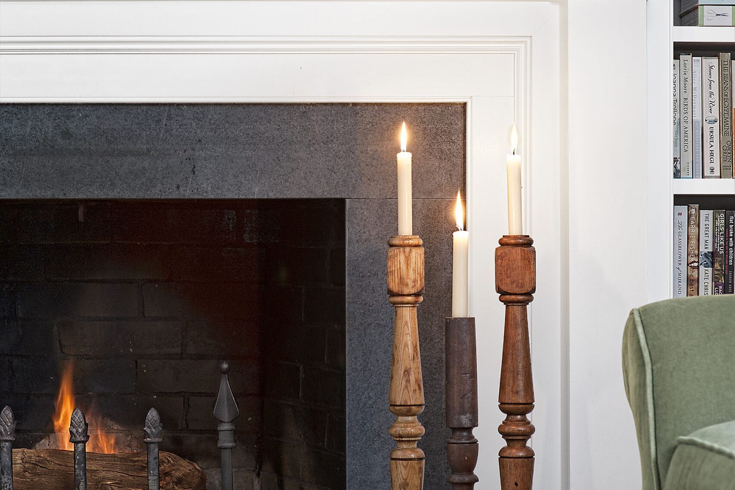 a candlestick made from a stair baluster next to a fireplace