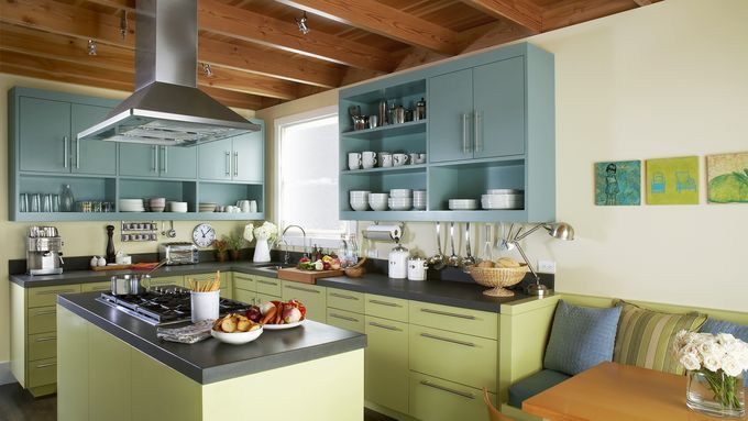 A kitchen with a vent hood over a stove.