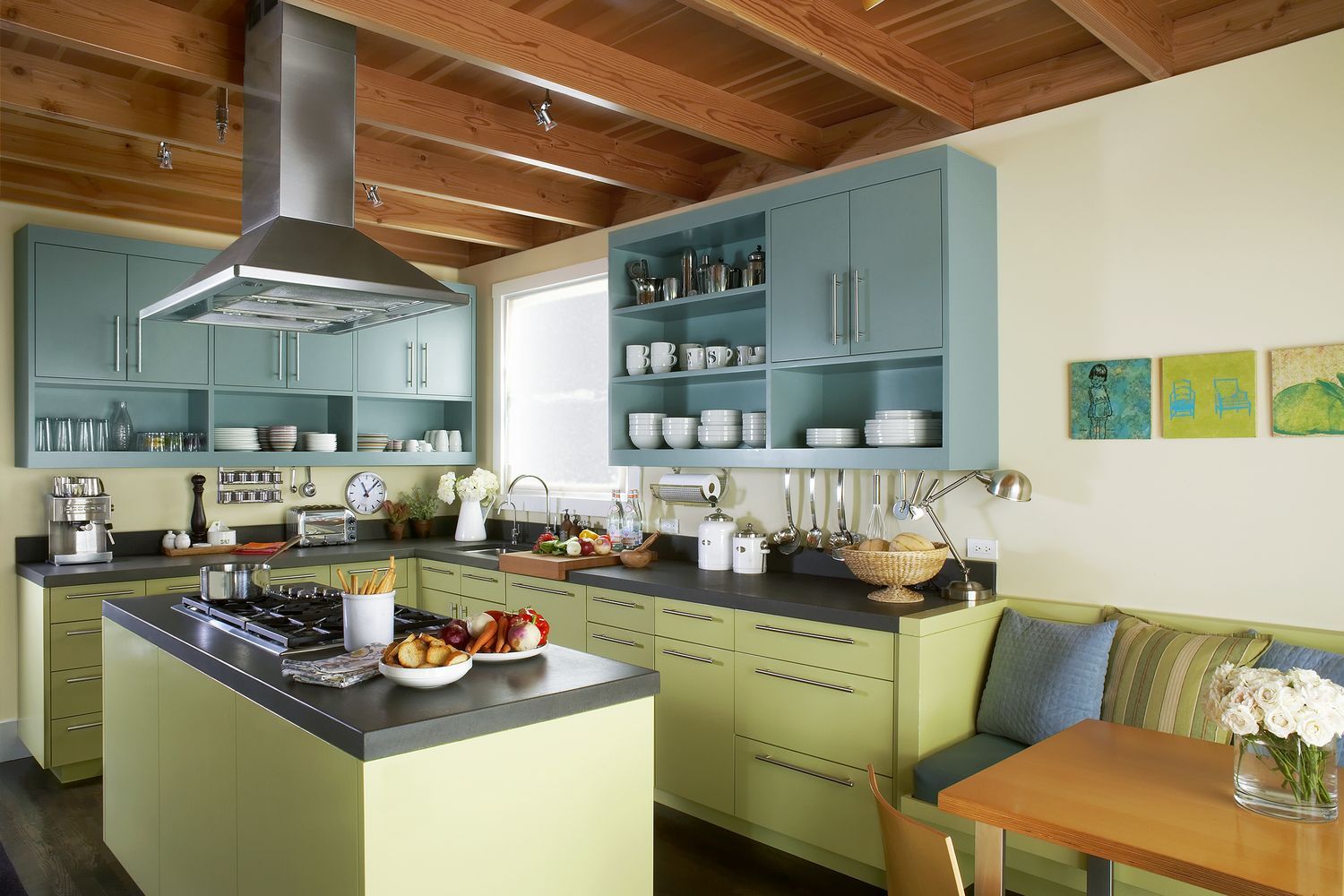 A kitchen with a vent hood over a stove.