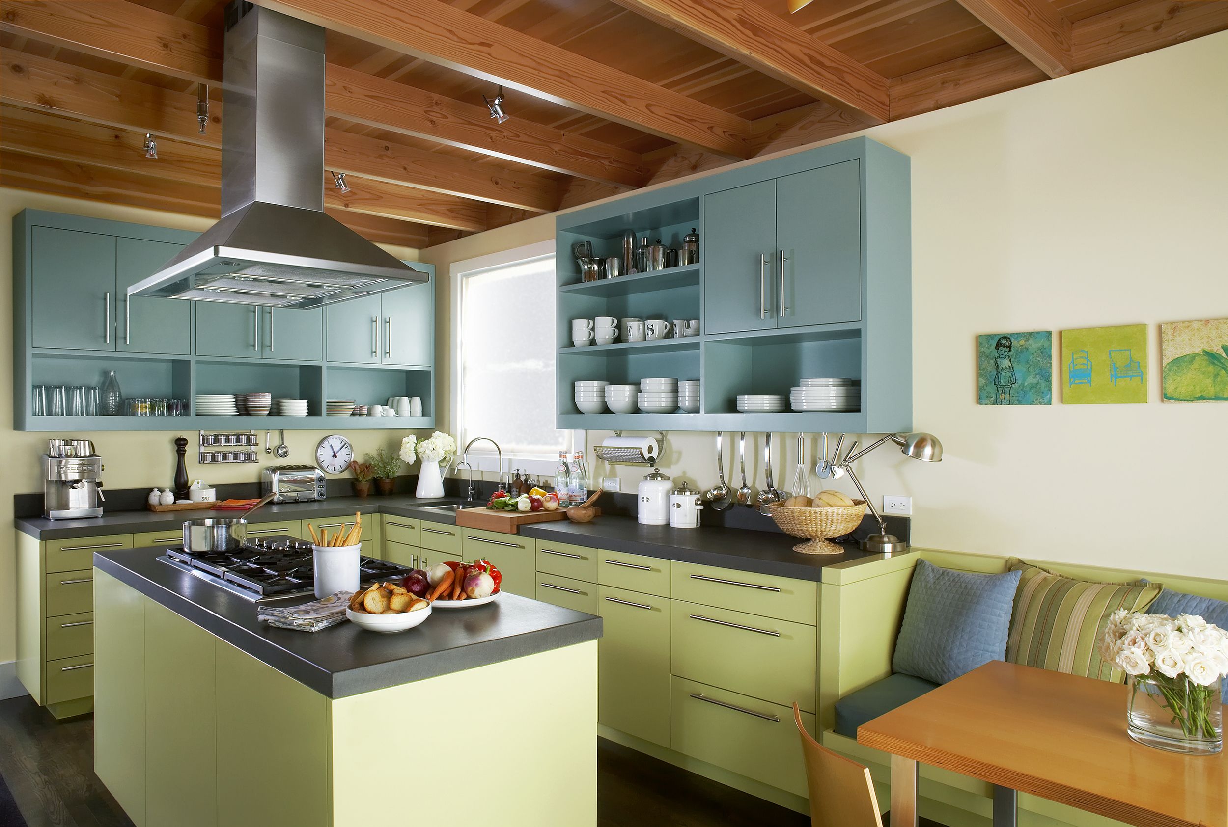 A kitchen with a vent hood over a stove.