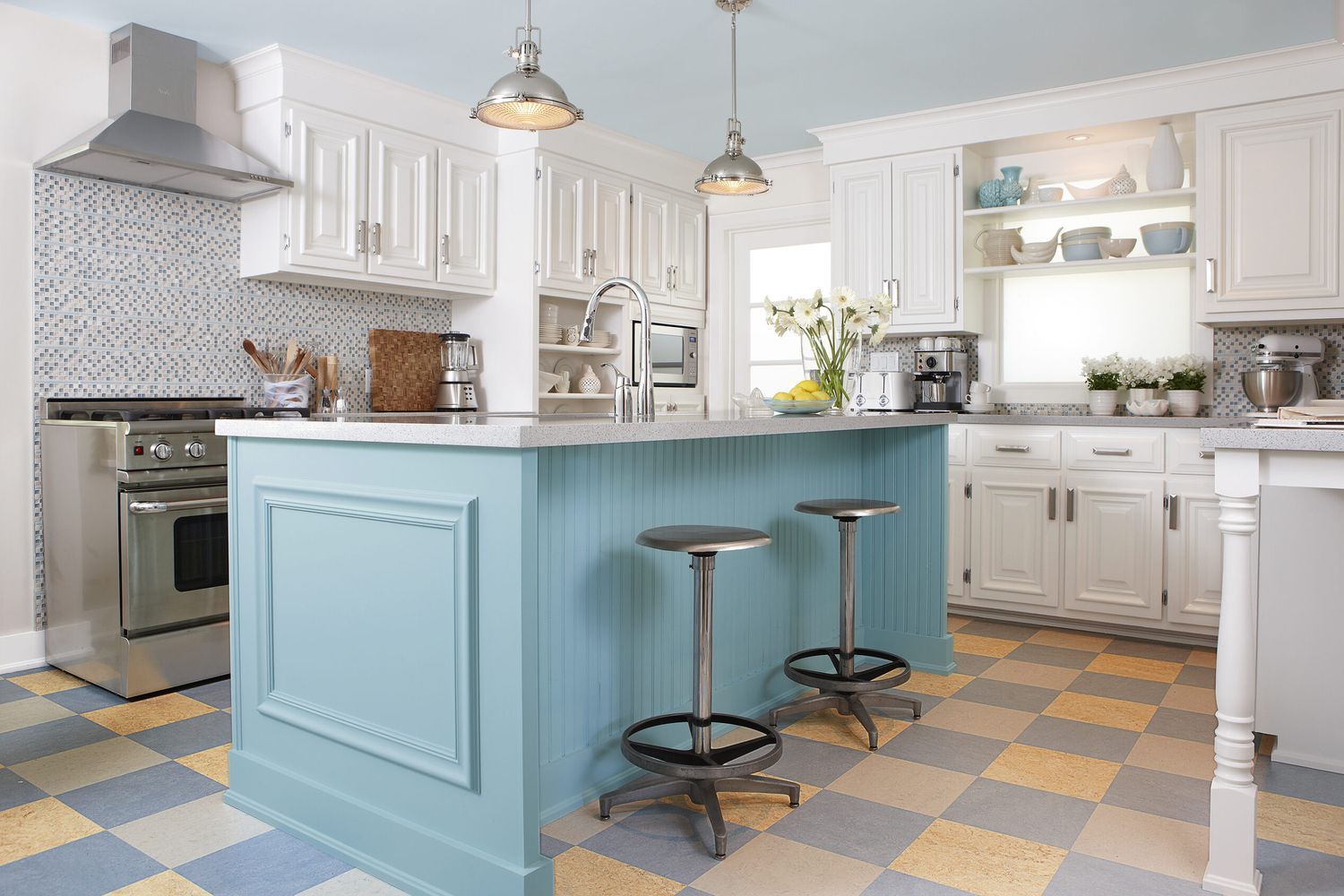 A kitchen with a two toned linoleum floor.