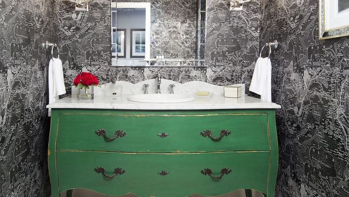 A vanity made out of a modified wooden dresser.