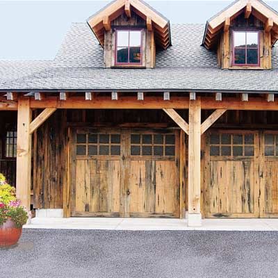 A home with rustic wooden garage doors.