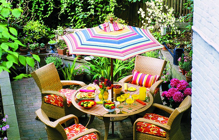 An outdoor dining space with a market umbrella.