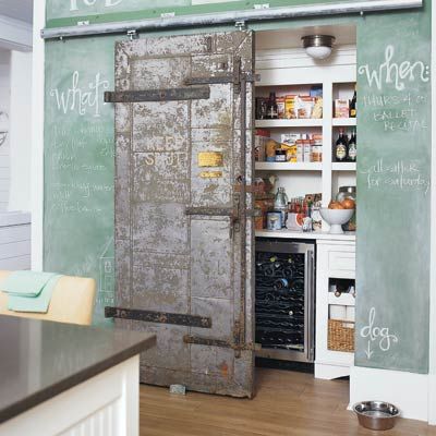 a sliding door that hides a pantry nook