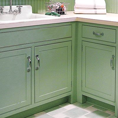 green cabinets within a laundry room