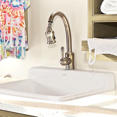 a laundry room sink with pull down faucets