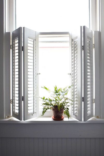 Wood shutters in a bathroom window.