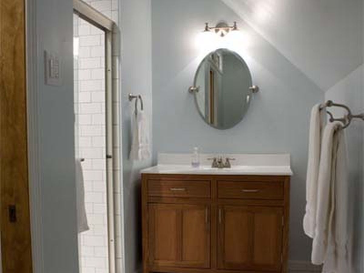 tan bathroom with red accents