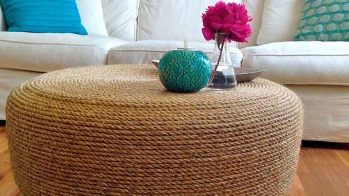 A rope ottoman in front of a white couch