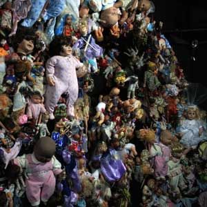 a wall of baby dolls in a haunted house