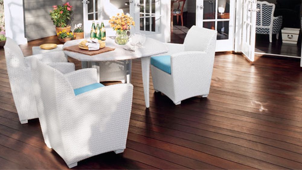 A hardwood deck with tables and chairs.