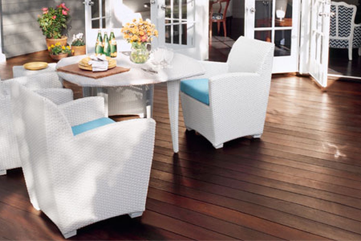 A hardwood deck with tables and chairs.