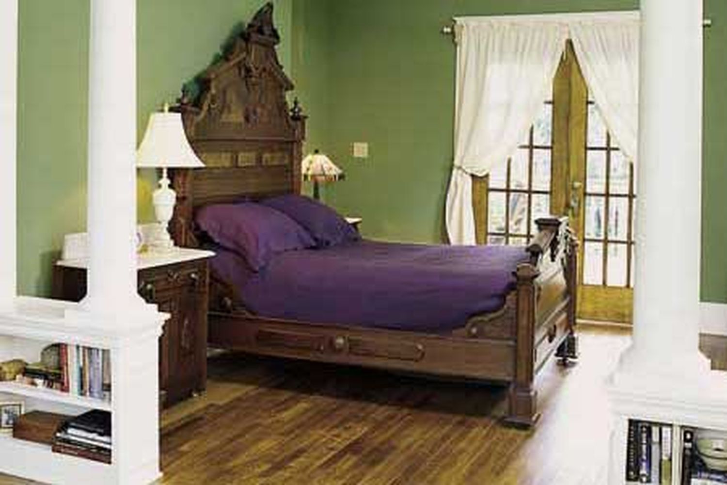 Green bedroom separated out by a temporary wall.