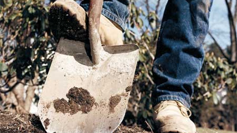 A person digging with a shovel.