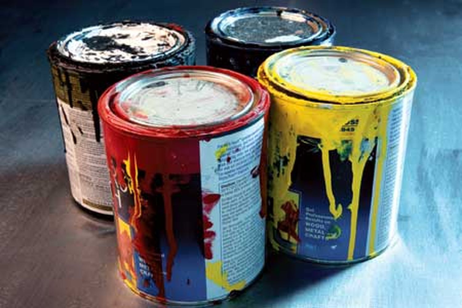 old paint cans of different colors