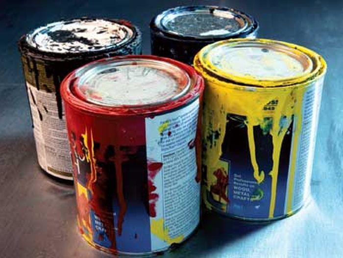 old paint cans of different colors