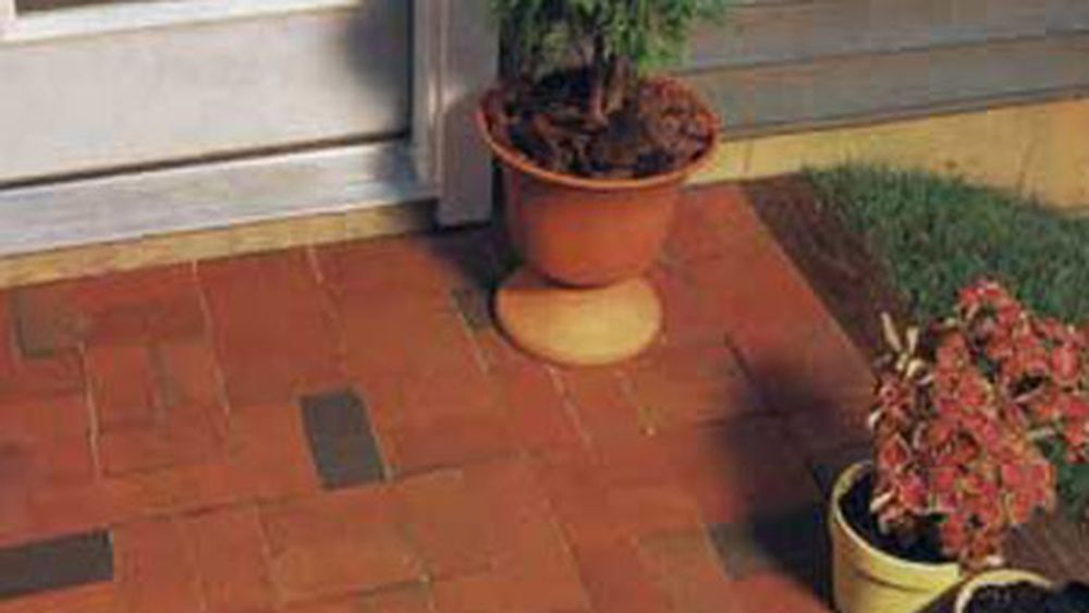 A brick patio in front of a building.