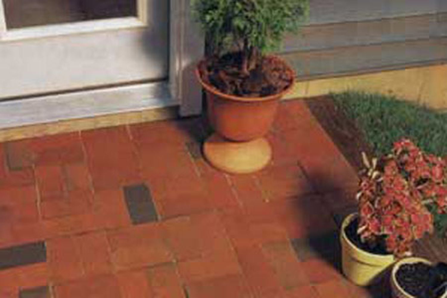 A brick patio in front of a building.