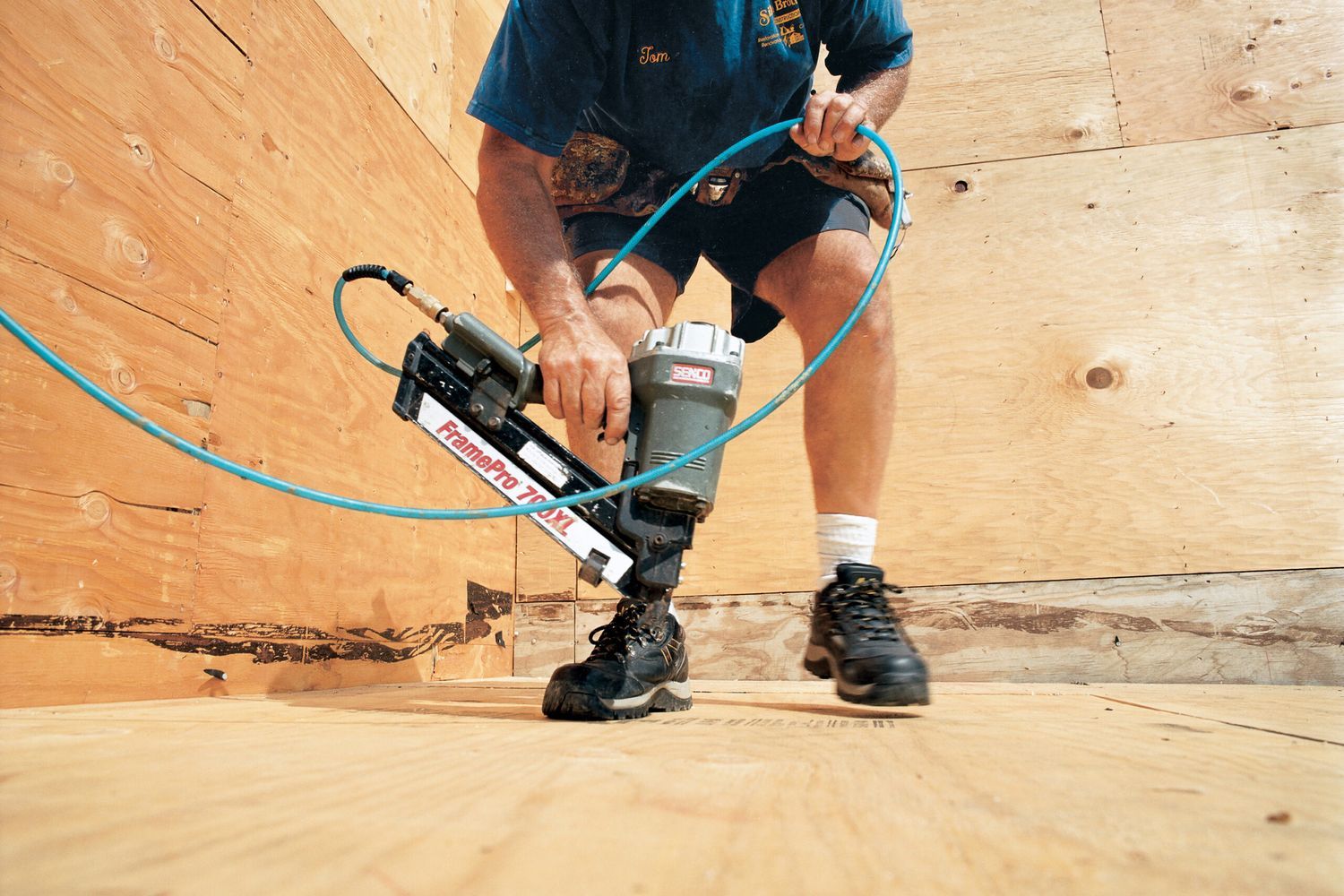 A man using a frame pro device to construct a flat roof.