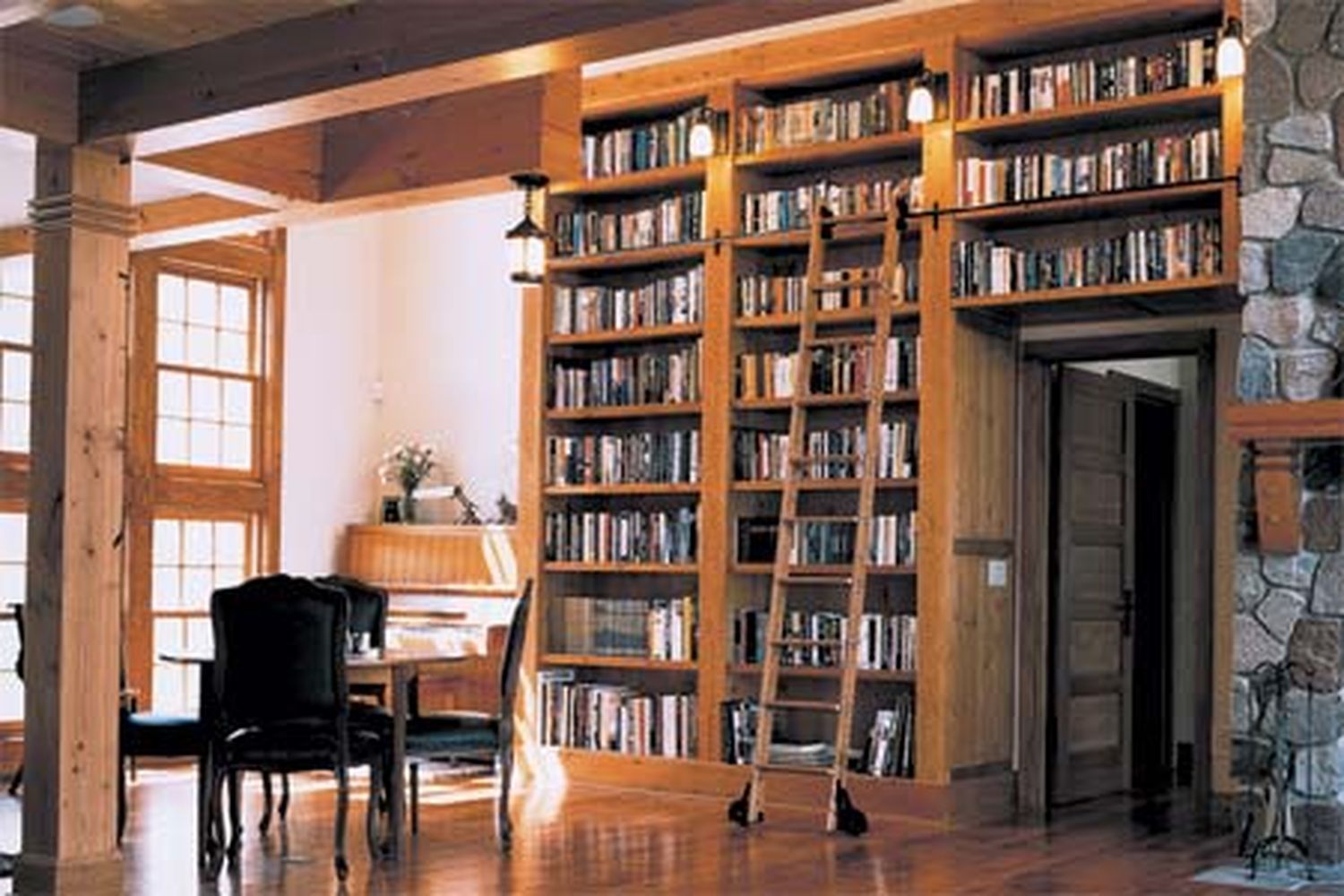 A room with large built in bookcases.