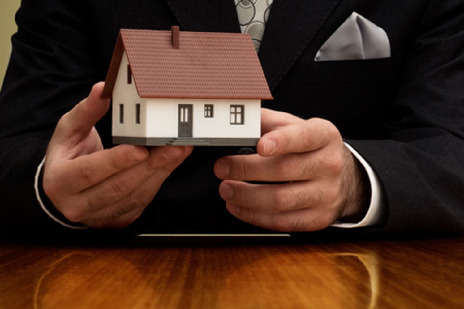 a real estate broker holding a model home