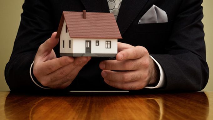 a real estate broker holding a model home