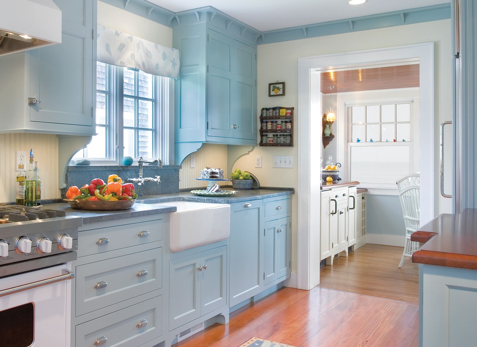 A luxurious white and blue kitchen with gold hardware, Bosch and