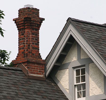 A chimney on a roof with straight flashing.