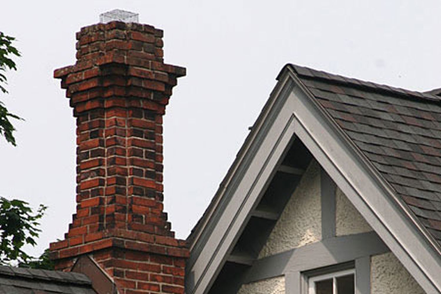 A brick chimney on top of a home.