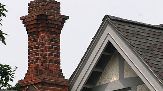 A brick chimney on top of a home.