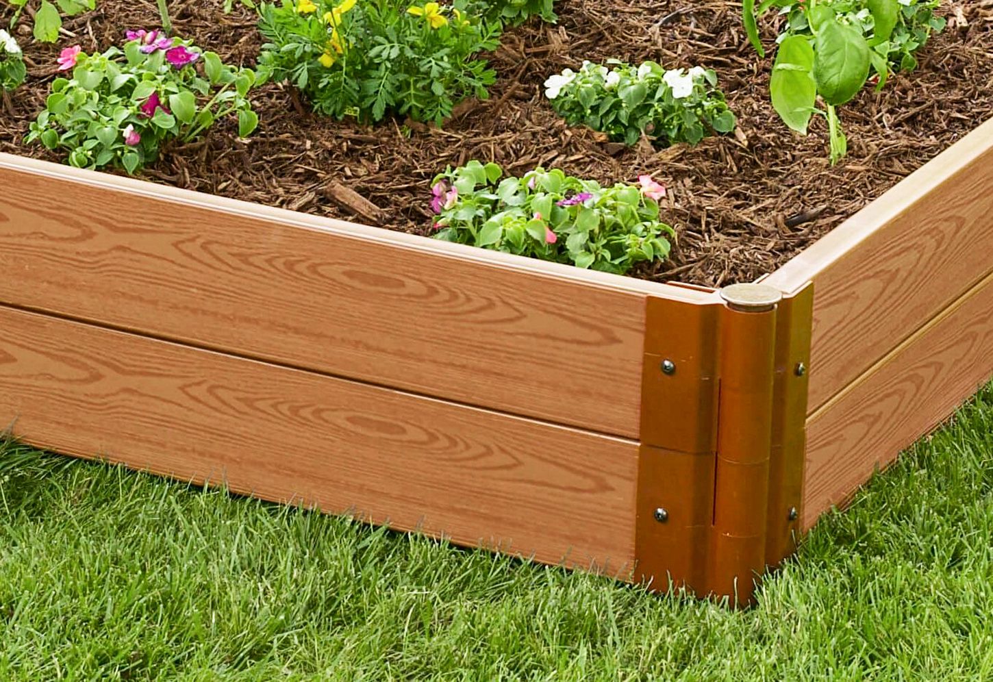 A composite garden bed sitting on a yard.