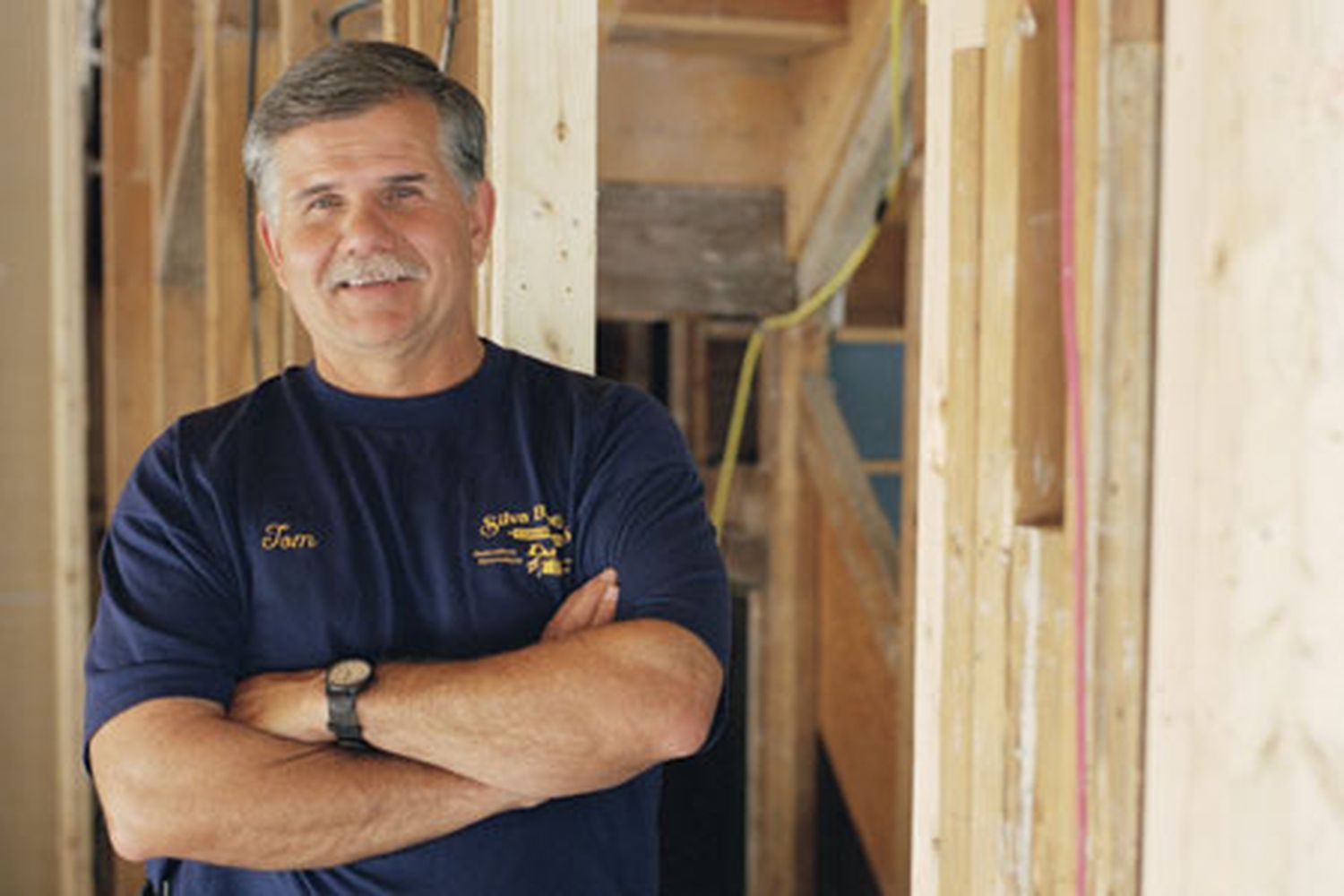 This Old House contractor Tom Silva posting in a construction site where new flooring will be laid soon.
