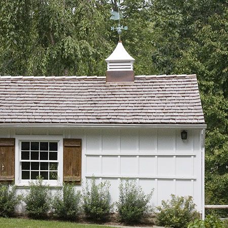 A home with a small cupola on top of it.