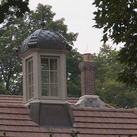 A building with an ornamental cupola on top of it.