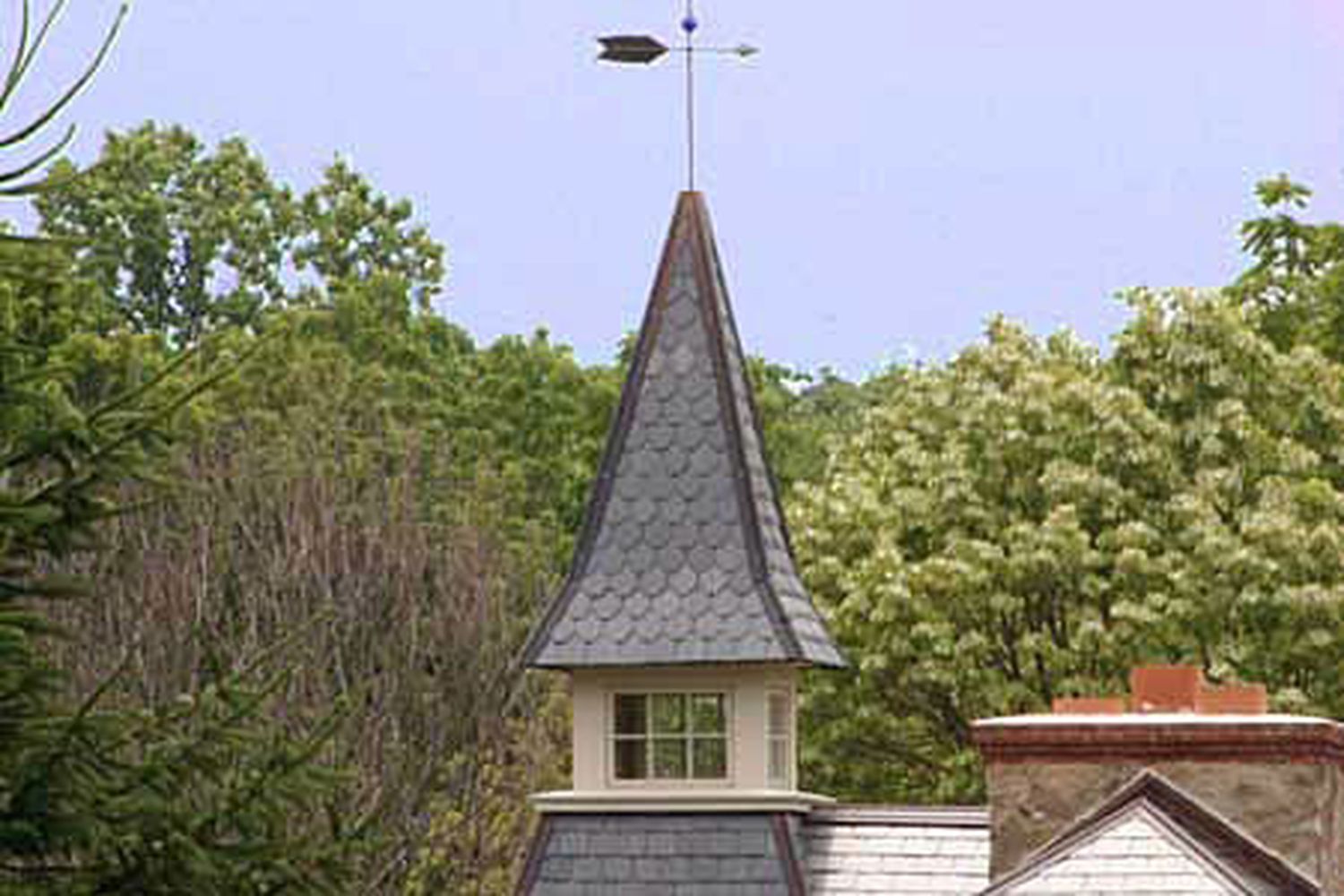 A building with a pointed cupola on top of it.