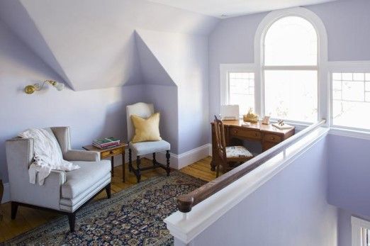 a loft with a large arched window