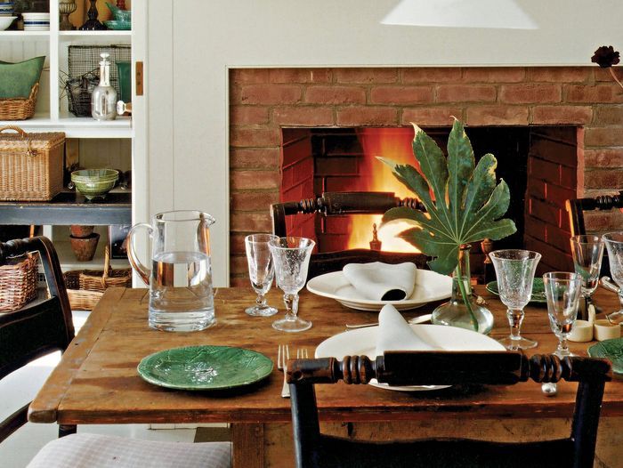 A dining room with a refinished table in the center.