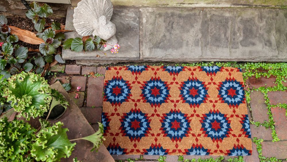 a colorful doormat outside a front door