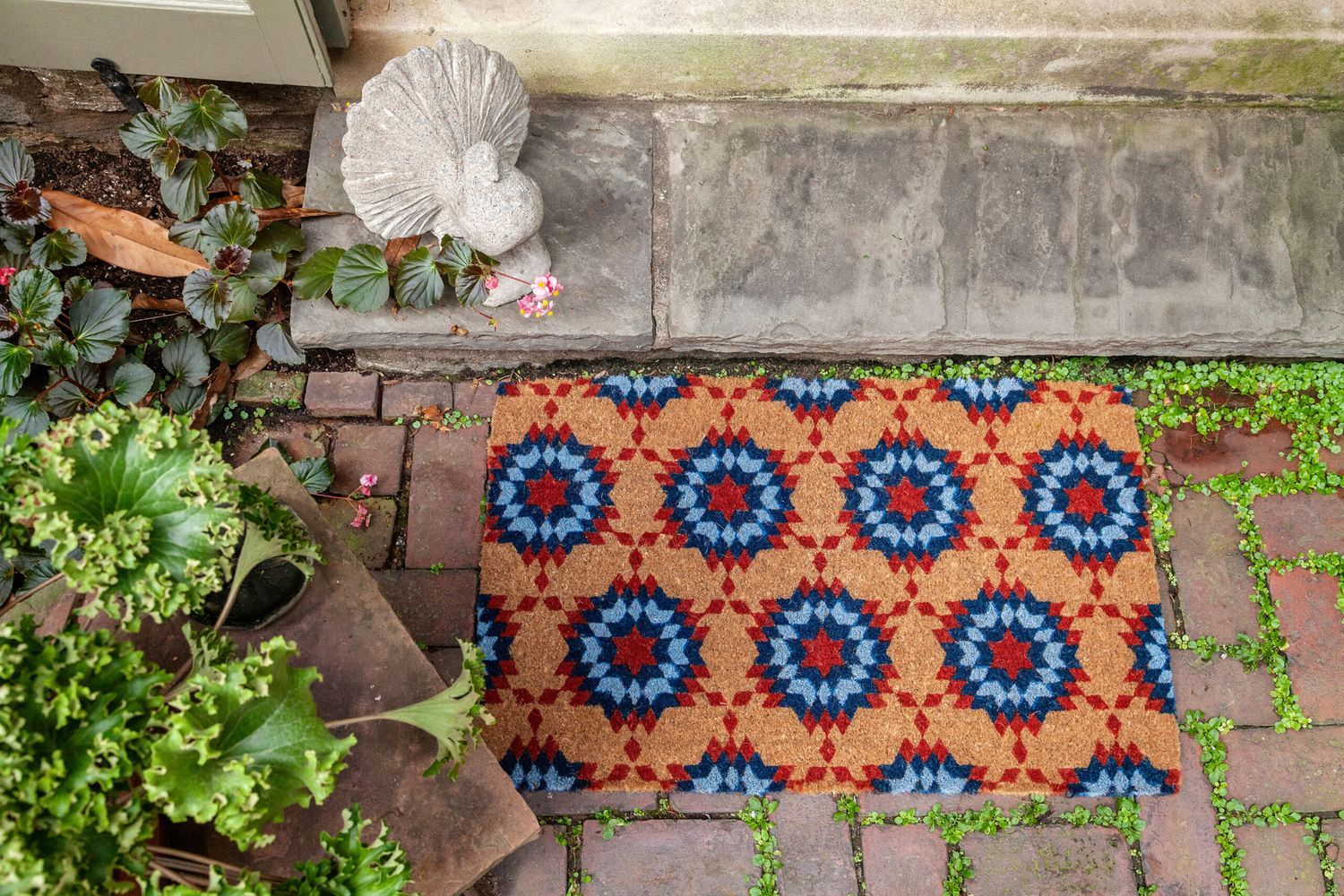a colorful doormat outside a front door