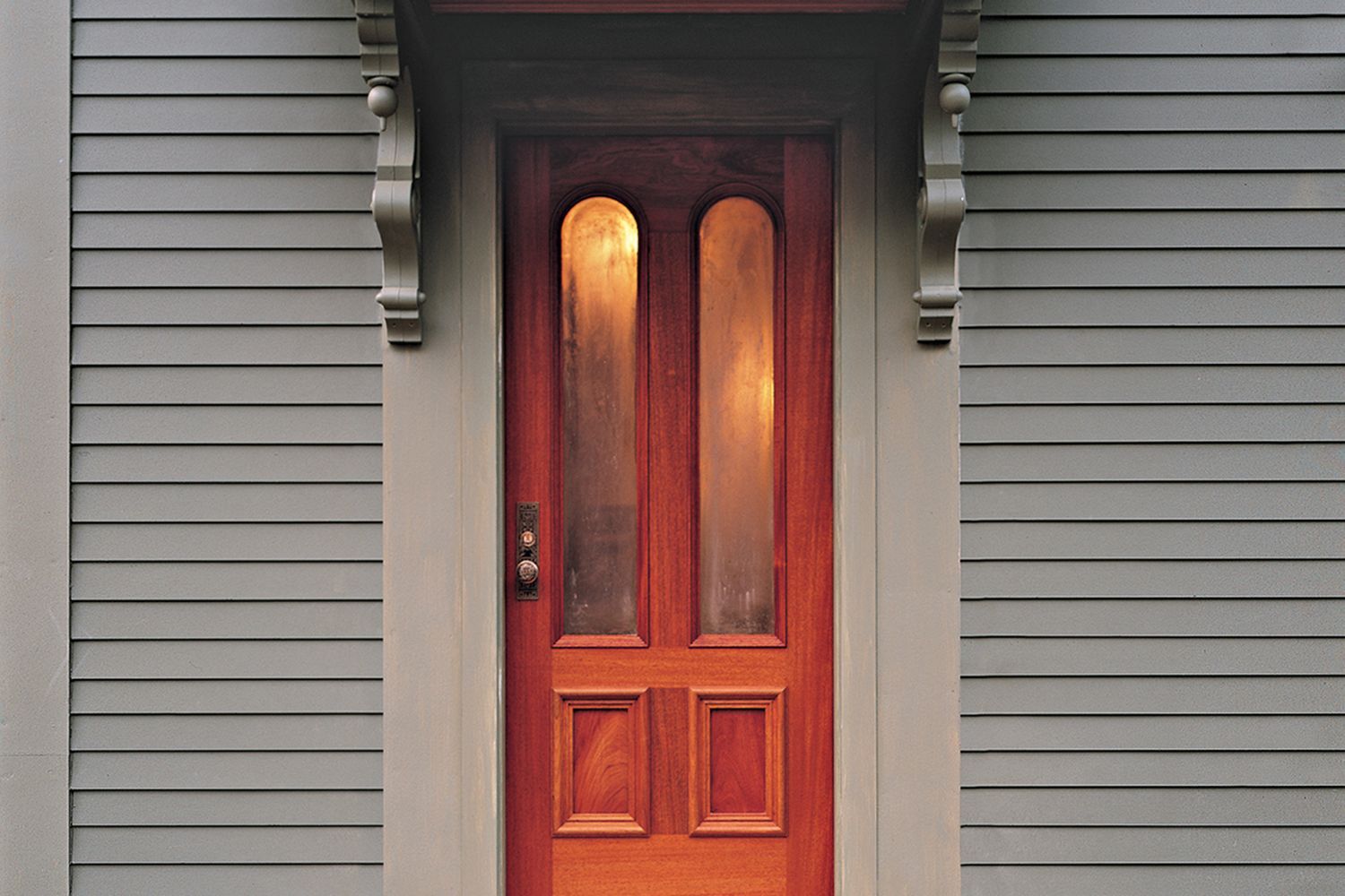 Picture of a residential home with a wooden entry door