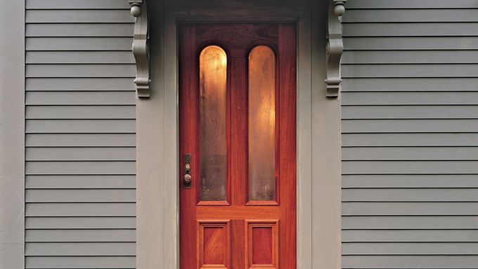 Picture of a residential home with a wooden entry door