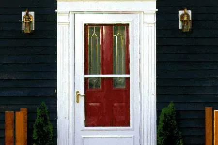 a newly installed door and storm door onto an entryway