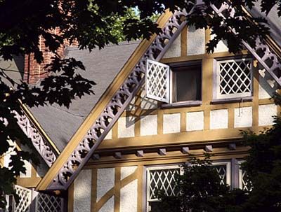 A white and yellow home with natural wood framing.